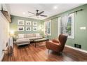 Cozy living room with wood floors, a modern ceiling fan, and a comfortable seating arrangement at 403 Red Oak Ln, Lawrenceville, GA 30046