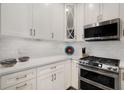 Well-lit kitchen features stainless steel appliances, white cabinets, and sleek countertops at 850 Piedmont Ne Ave # 1206, Atlanta, GA 30308