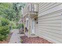 View of the side of the home with a balcony and landscaping at 1315 Old Coach Sw Rd, Marietta, GA 30008