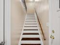 View of a staircase with wooden steps and a wooden handrail at 1315 Old Coach Sw Rd, Marietta, GA 30008