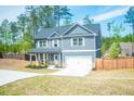 Exterior of a two-story home with gray siding, white trim, well-kept landscaping, and a two car attached garage at 284 Bryson Lake Cir, Douglasville, GA 30134