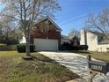 Exterior shot of a single-Gathering home, showcasing the brick and siding, with a driveway and mailbox at 4192 Medlock River Ct, Snellville, GA 30039