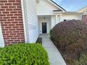 Close up on front door, featuring a black front door, white columns, and lush landscaping at 4192 Medlock River Ct, Snellville, GA 30039