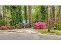 Single-story home surrounded by lush greenery and flowering azalea bushes at 1340 Nerine Cir, Atlanta, GA 30338
