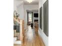 Inviting hallway featuring hardwood floors and views into the living room at 1720 Barclay Close Nw, Atlanta, GA 30318