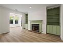 Bright living room showcases a fireplace with built-in shelving and large windows at 1923 Brian Way # 1923, Decatur, GA 30033