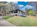 A freshly painted home with a covered patio and a large manicured yard at 3340 Brenda Ln, Lithia Springs, GA 30122