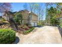 Spacious driveway leads to an attached two-car garage with a manicured garden along the driveway at 3897 Beacon St, Marietta, GA 30062