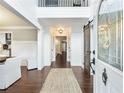 Bright foyer with dark wood floors, shiplap walls, and distinctive sliding barn door at 3965 Hamilton View Way, Dacula, GA 30019