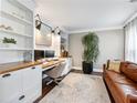 Comfortable home office featuring built-in bookshelves and a leather sofa at 3965 Hamilton View Way, Dacula, GA 30019