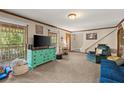 Spacious living room with a large window, neutral walls, and a comfortable seating area at 5269 Blue Grass Ln, Sugar Hill, GA 30518
