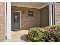 Close-up of the front porch with a decorated gray front door and colorful flower bed at 234 Madison Ave, Acworth, GA 30102