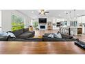 Bright living room features a fireplace, vaulted ceilings, and access to an eat-in kitchen at 3378 Peachtree Chase, Duluth, GA 30096