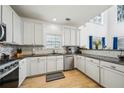 Modern kitchen with white cabinets, stainless steel appliances, granite countertops, and lots of natural light at 3800 Lake Pass Ln, Suwanee, GA 30024
