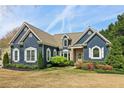 Charming two-story home boasts a well-manicured front yard, stone accents and a welcoming front porch at 2305 Stonevalley Ct, Cumming, GA 30041