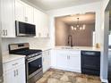 Bright kitchen with white cabinets, stainless steel appliances, and black accents at 801 Old Peachtree Nw Rd # 15, Lawrenceville, GA 30043