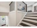 Inviting foyer features a staircase with iron spindles and a clear view of the front door with decorative wreath at 2048 Violet Lane, Brookhaven, GA 30319