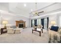 Spacious living room with a fireplace, carpet, and ceiling fan at 434 Meadowfield Ct, Lawrenceville, GA 30043