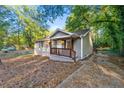 Charming single-story home with a cozy front porch and traditional wood shutters at 831 Mercury Nw Dr, Atlanta, GA 30331
