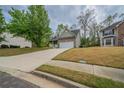 Charming home with a long driveway, inviting facade, and manicured lawn at 2899 Duncan Pl, Decatur, GA 30034
