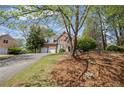 Attractive brick home with an attached two-car garage, mature trees, and manicured landscaping at 5628 Fallsbrook Nw Knl, Acworth, GA 30101