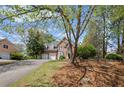 Lovely brick home with an attached two-car garage, mature trees, and manicured landscaping at 5628 Fallsbrook Nw Knl, Acworth, GA 30101