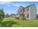 Two-story home featuring manicured lawn and well-maintained landscaping at 1027 Fellowship Rd, Fairburn, GA 30213