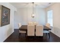 Formal dining room featuring a wooden table, upholstered chairs, and modern lighting at 1800 Pearson St, Loganville, GA 30052
