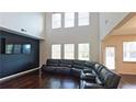 Bright living room features a two-story ceiling and a modern accent wall at 1800 Pearson St, Loganville, GA 30052