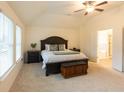 Vaulted ceiling primary bedroom with large windows and en suite bathroom at 1800 Pearson St, Loganville, GA 30052