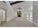 Spacious living room with stone fireplace, vaulted ceiling, and access to backyard at 4111 Sweet Water Ct, Conyers, GA 30094