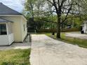 View of the long driveway on the side of the house with lawn at 6286 Cooper St, Douglasville, GA 30134