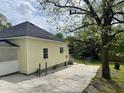Side view of the exterior showing a concrete driveway and a small patch of lawn at 6286 Cooper St, Douglasville, GA 30134