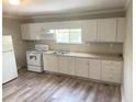 Bright kitchen featuring white cabinets, neutral countertops, and stainless steel appliances at 6286 Cooper St, Douglasville, GA 30134