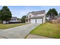 Charming two-story home with a two-car garage, stone accents and a well-manicured front yard at 2828 Marksman Trl, Austell, GA 30106