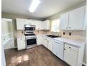 Well-lit kitchen with white cabinets, stainless steel appliances, and tile backsplash at 1535 Wilkes Crest Dr, Dacula, GA 30019