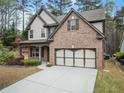 Stunning two-story home with brick and siding, a manicured lawn, and an attached two-car garage at 2172 Misty Brook Ct, Buford, GA 30519