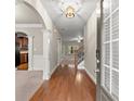 Inviting foyer with hardwood floors, arched doorways, and a view to the kitchen and staircase at 2172 Misty Brook Ct, Buford, GA 30519