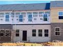 Rear of brick townhomes under construction showing bricked lower levels and covered upper levels with windows at 3104 Marbella Cir # 2, Kennesaw, GA 30152
