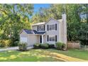 Charming two-story home with a manicured lawn and attached one car garage at 5570 Downs Way, Lithonia, GA 30058