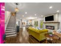 Spacious living room featuring hardwood floors, stylish fireplace and staircase at 791 Woodland Se Ave, Atlanta, GA 30316