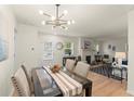Bright dining room featuring modern light fixture and view to the living room, perfect for entertaining at 1990 Venetian Sw Dr, Atlanta, GA 30311