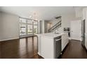 Open concept living and kitchen area with hardwood floors and stainless steel appliances at 6812 Cadence Blvd, Atlanta, GA 30328