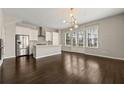 Bright living room featuring hardwood floors, modern lighting, and large windows at 6812 Cadence Blvd, Atlanta, GA 30328