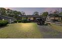Cozy one-story brick home at dusk with a green lawn, blending into the neighborhood's serene setting at 131 Brownlee Rd, Atlanta, GA 30331