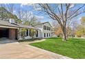 Charming two-story home with a well-maintained lawn, black shutters and mature trees at 2491 Falcon Ridge Dr, Grayson, GA 30017