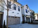 Lovely exterior view of modern townhomes with light-colored facades and attached garages at 407 Johnson Ct, Alpharetta, GA 30009