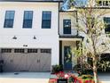 Beautiful townhome featuring brick accents, a two-car garage and meticulously landscaped yard at 407 Johnson Ct, Alpharetta, GA 30009