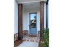 Covered entryway with decorative door, brick accents, and wood columns at 407 Johnson Ct, Alpharetta, GA 30009