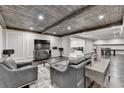 Spacious finished basement with exposed wood ceiling, gray walls, and stylish furnishings at 7940 Royal Melbourne Way, Duluth, GA 30097